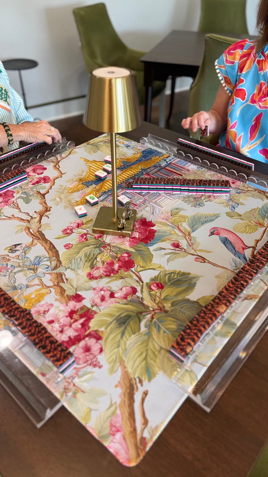 Players enjoying American mahjong at a styled Mahjong Open table.