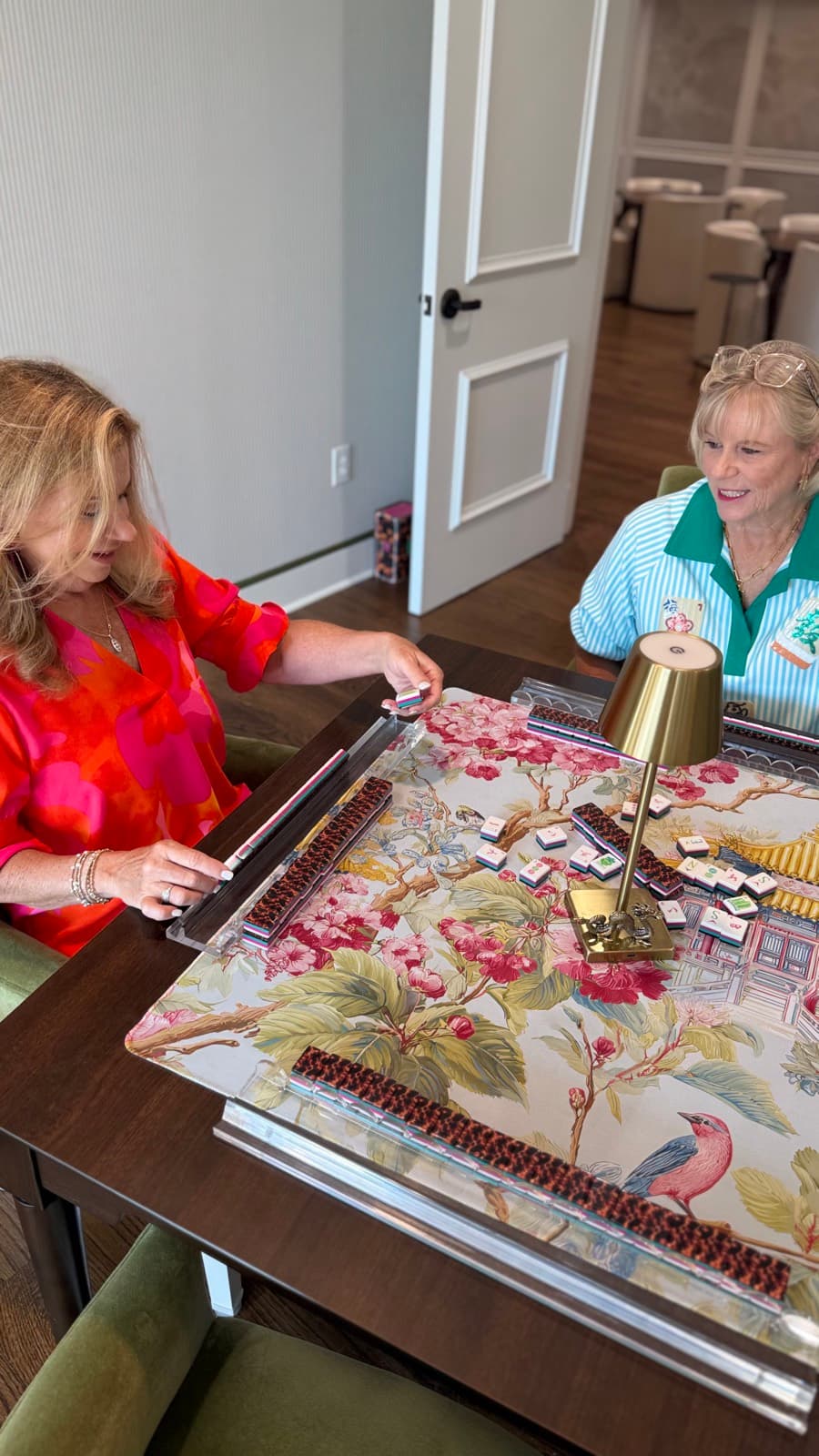 Friends gathered around the table on a Mahjong Open league night.