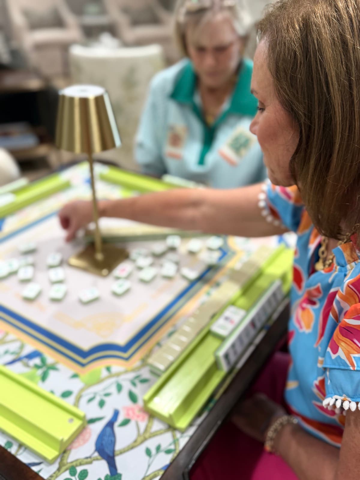 Players enjoying American mahjong at a styled Mahjong Open table.