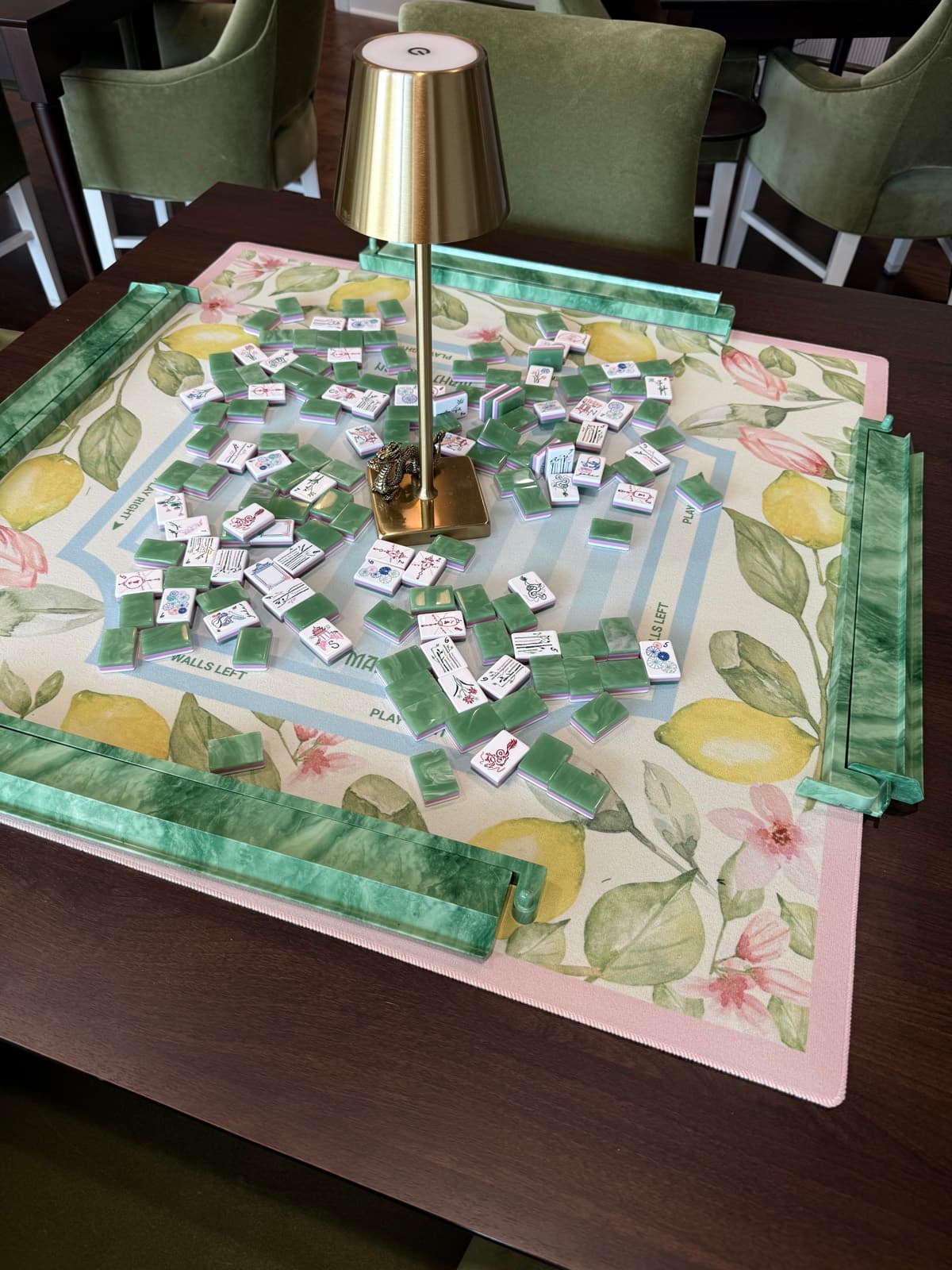 Players enjoying American mahjong at a styled Mahjong Open table.