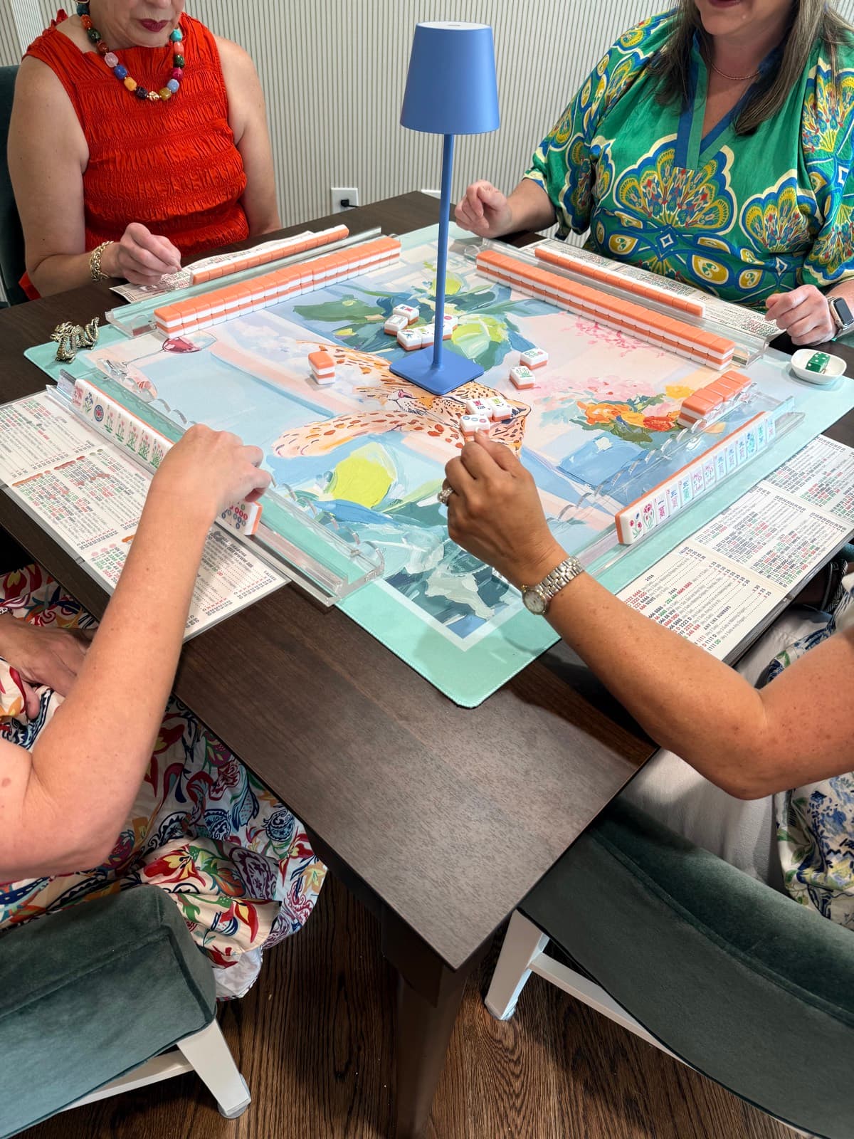 Players enjoying American mahjong at a styled Mahjong Open table.